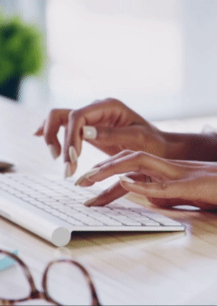 Hands typing on a keyboard