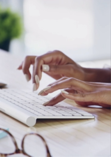 Hands typing on a keyboard